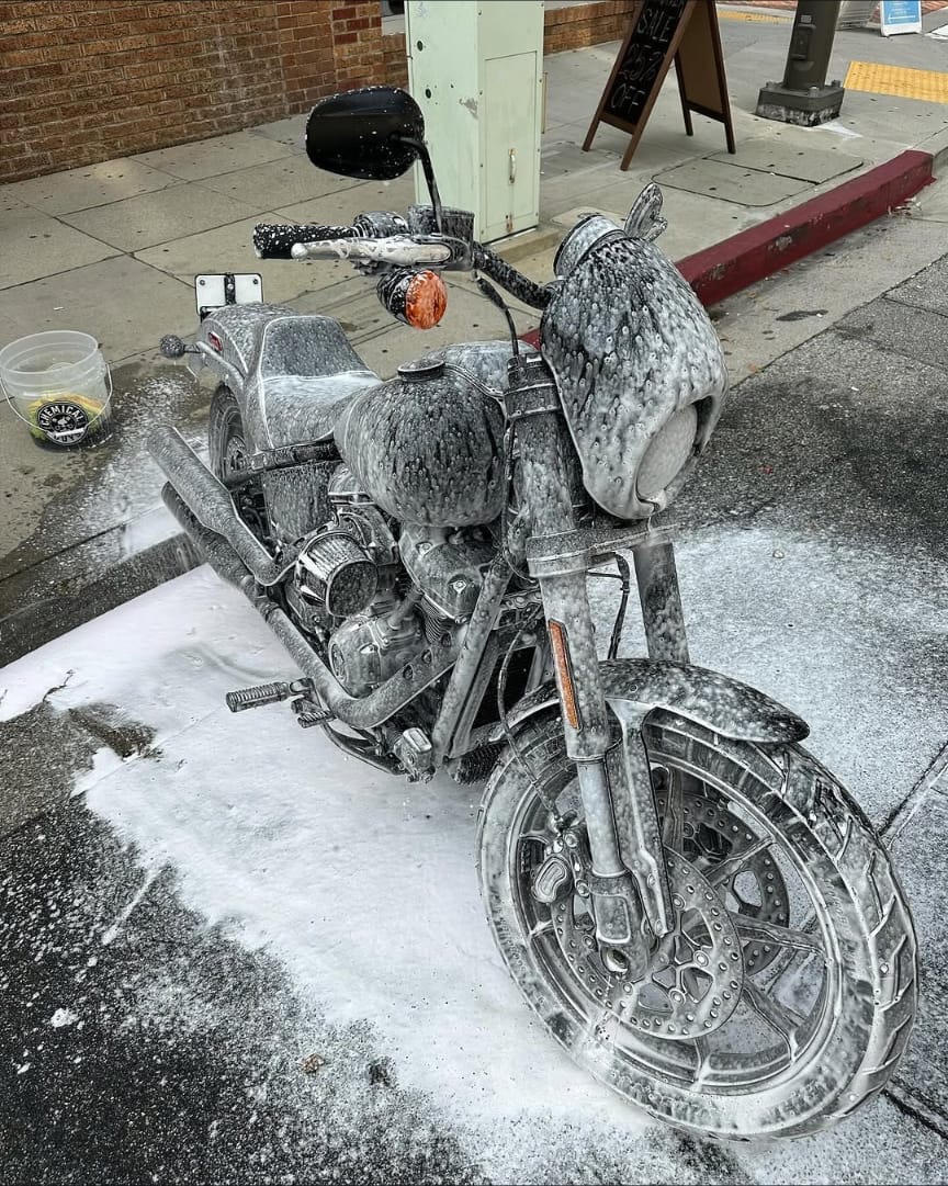 Harley-Davidson motorcycle covered in foam during the wash