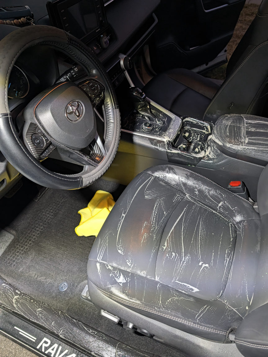 White Toyota RAV4 leather seat being cleaned