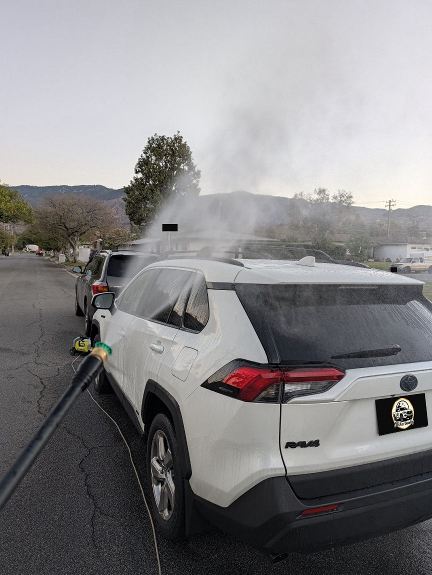 White Toyota RAV4 rinse with pressure washer