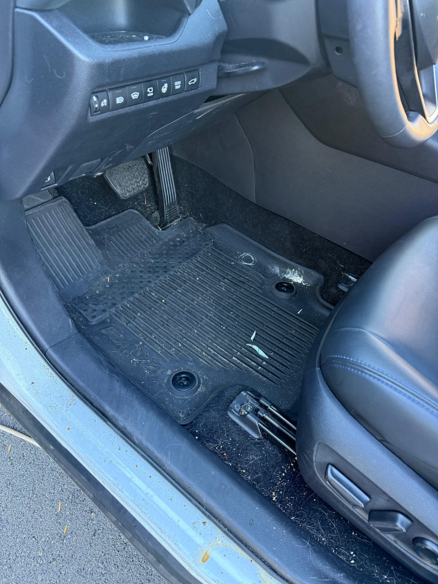 White Toyota RAV4 driver floor before detailing